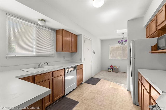 31450 Orchard Brook Ct Unit 8, Farmington Hills, MI 48336 - kitchen featuring dishwashing machine, brown cabinetry, light countertops, and black microwave