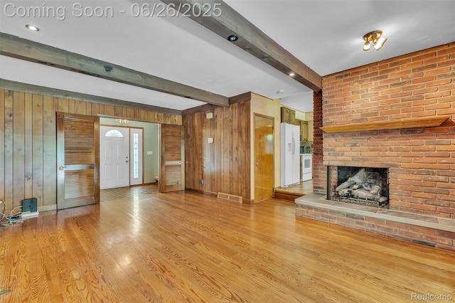 1840 Glen Iris Dr, Commerce Twp, MI 48382 - unfurnished living room with wooden walls, beamed ceiling, light wood-style floors, and a brick fireplace