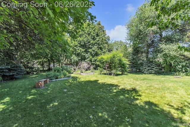 1840 Glen Iris Dr, Commerce Twp, MI 48382 - view of green lawn featuring a vegetable garden