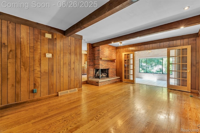 1840 Glen Iris Dr, Commerce Twp, MI 48382 - unfurnished living room with wood walls, wood finished floors, beam ceiling, and a fireplace