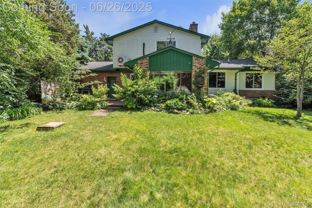 1840 Glen Iris Dr, Commerce Twp, MI 48382 - back of house with brick siding, a lawn, and a chimney