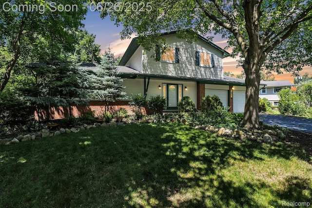 1840 Glen Iris Dr, Commerce Twp, MI 48382 - traditional-style house featuring a garage, a lawn, driveway, and brick siding