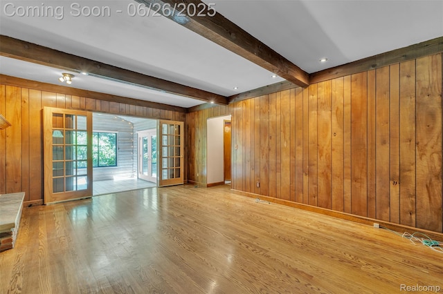 1840 Glen Iris Dr, Commerce Twp, MI 48382 - unfurnished living room with beam ceiling, wooden walls, wood finished floors, and french doors