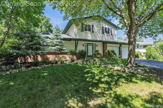 1840 Glen Iris Dr, Commerce Twp, MI 48382 - view of front facade with a front yard, driveway, a garage, and brick siding
