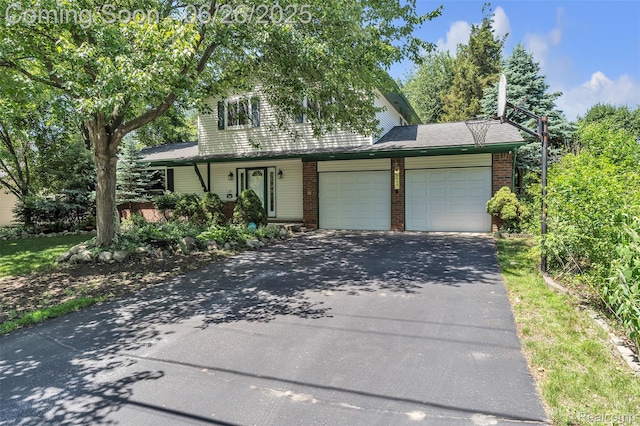 1840 Glen Iris Dr, Commerce Twp, MI 48382 - view of front of property with asphalt driveway, brick siding, and a garage