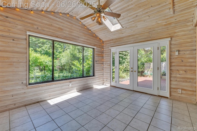 1840 Glen Iris Dr, Commerce Twp, MI 48382 - unfurnished room featuring wooden walls, lofted ceiling, tile patterned flooring, a skylight, and a ceiling fan