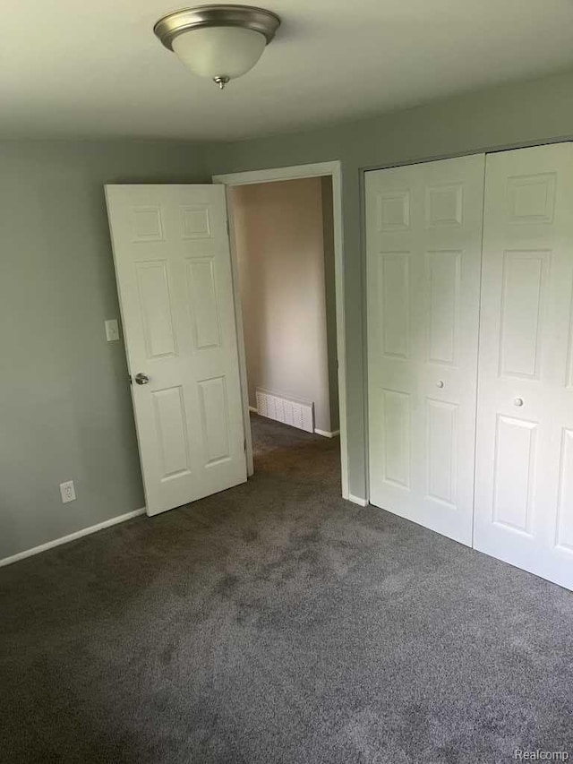 2162 W Coldwater Rd, Flint, MI 48505 - unfurnished bedroom with dark carpet and a closet