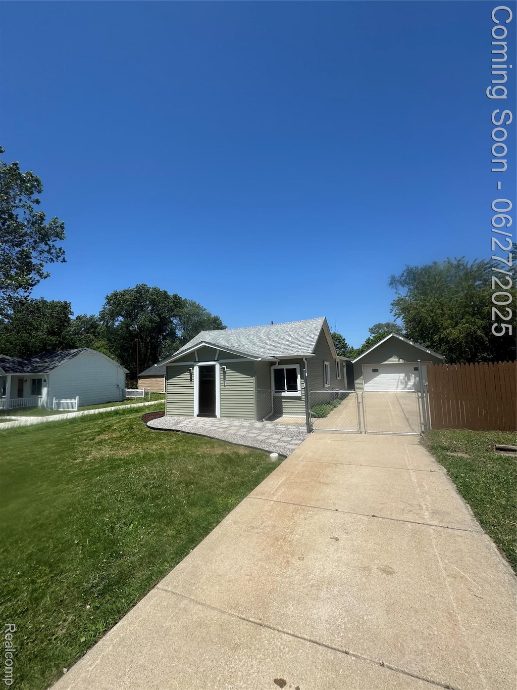 21705 Maxine St, Macomb, MI 48080 - single story home featuring a gate, driveway, and a garage