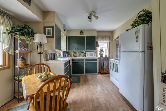 2030 W Sterns Rd, Temperance, MI 48182 - kitchen with white appliances, light wood-style flooring, light countertops, and green cabinets