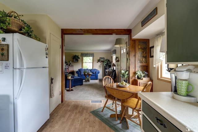 2030 W Sterns Rd, Temperance, MI 48182 - kitchen featuring freestanding refrigerator, light wood-type flooring, and beamed ceiling