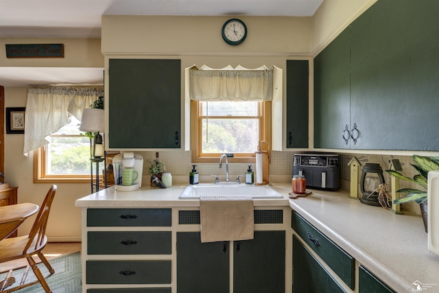 2030 W Sterns Rd, Temperance, MI 48182 - kitchen with tasteful backsplash, plenty of natural light, and light countertops