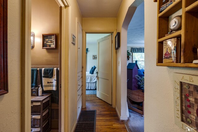 2030 W Sterns Rd, Temperance, MI 48182 - hallway featuring dark wood-style floors and arched walkways