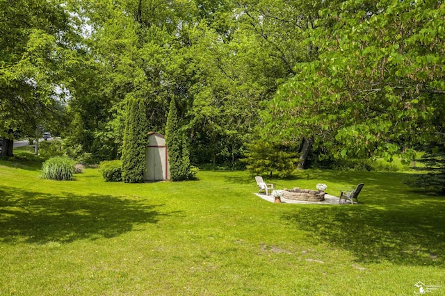 2030 W Sterns Rd, Temperance, MI 48182 - view of grassy yard featuring a shed and an outdoor fire pit
