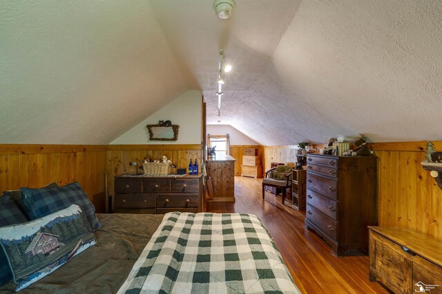 2030 W Sterns Rd, Temperance, MI 48182 - bedroom featuring wood walls, a textured ceiling, wood-type flooring, and lofted ceiling