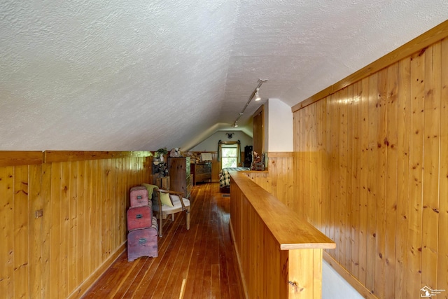 2030 W Sterns Rd, Temperance, MI 48182 - additional living space with wooden walls, a textured ceiling, dark wood-style flooring, and vaulted ceiling
