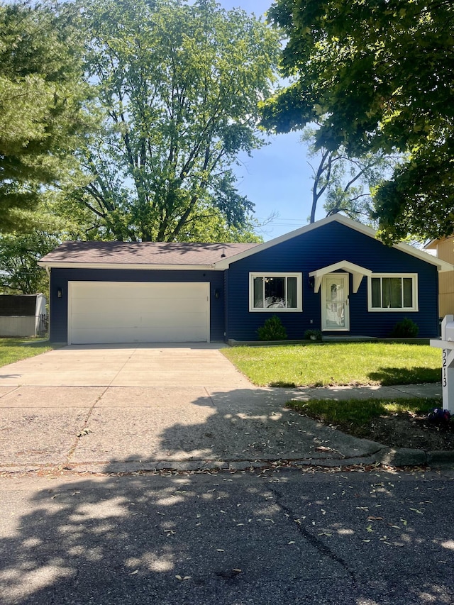 5213 Crocus Ave, Lansing, MI 48911 - view of front facade featuring a garage, driveway, and a front lawn