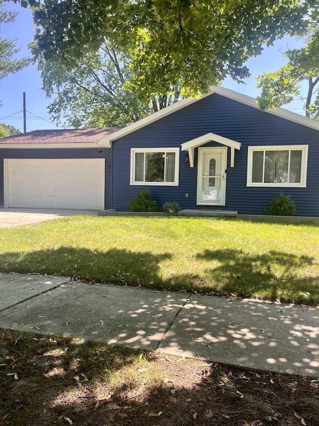 5213 Crocus Ave, Lansing, MI 48911 - view of front of house featuring a garage, a front lawn, and concrete driveway