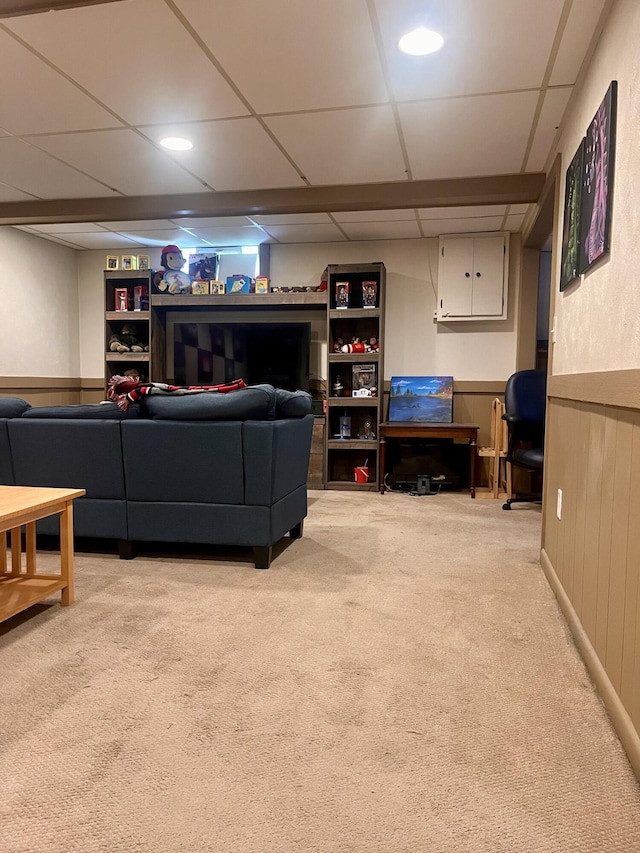 5213 Crocus Ave, Lansing, MI 48911 - living area featuring a paneled ceiling, light carpet, and wainscoting