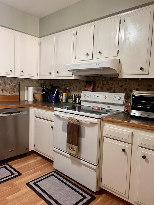5213 Crocus Ave, Lansing, MI 48911 - kitchen featuring dishwasher, under cabinet range hood, electric stove, dark countertops, and backsplash