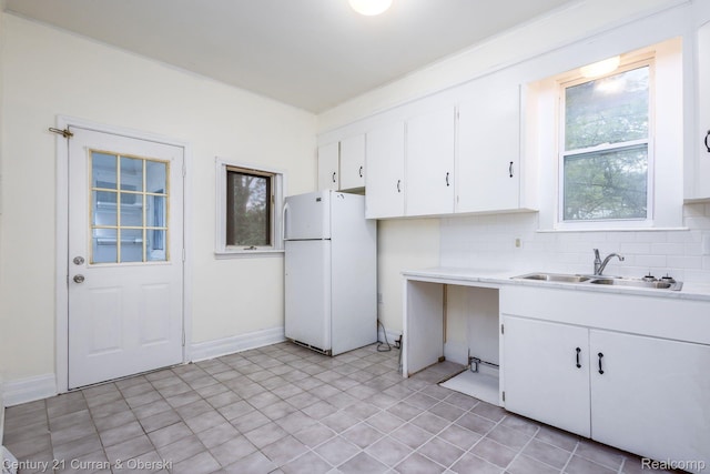 28604 Grayling Ave, Farmington Hills, MI 48336 - kitchen featuring freestanding refrigerator, light countertops, white cabinetry, and backsplash