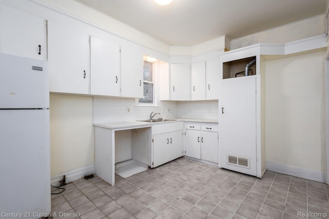 28604 Grayling Ave, Farmington Hills, MI 48336 - kitchen with freestanding refrigerator, light countertops, tasteful backsplash, and white cabinets