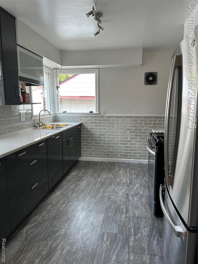 8816 Salem Ln, Redford, MI 48239 - kitchen featuring appliances with stainless steel finishes, modern cabinets, dark cabinetry, and a wainscoted wall