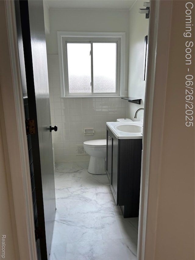 8816 Salem Ln, Redford, MI 48239 - bathroom featuring vanity, marble look tile flooring, and tile walls