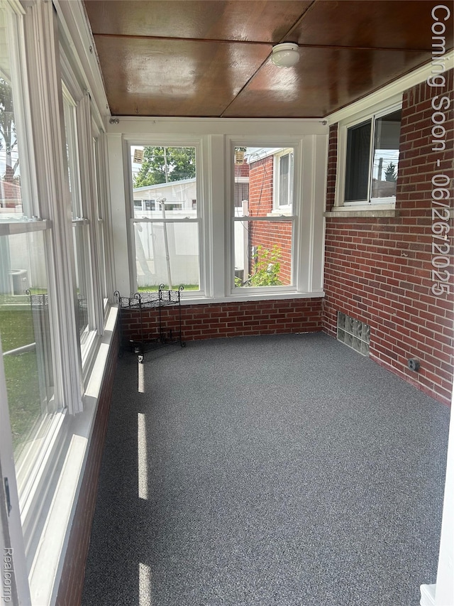8816 Salem Ln, Redford, MI 48239 - unfurnished sunroom featuring brick wall and carpet