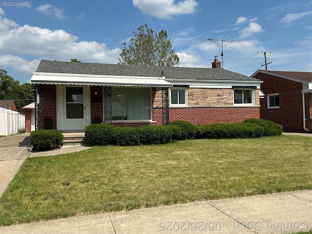8816 Salem Ln, Redford, MI 48239 - view of front of house featuring a front yard, brick siding, and a chimney