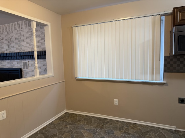 5839 Ballfour, Allen Park, MI 48101 - spare room featuring baseboards and a fireplace