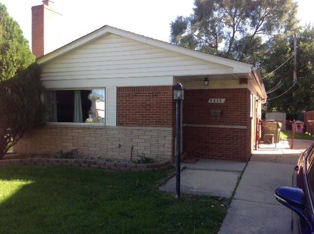 5839 Ballfour, Allen Park, MI 48101 - view of home's exterior with brick siding, a chimney, and a gate