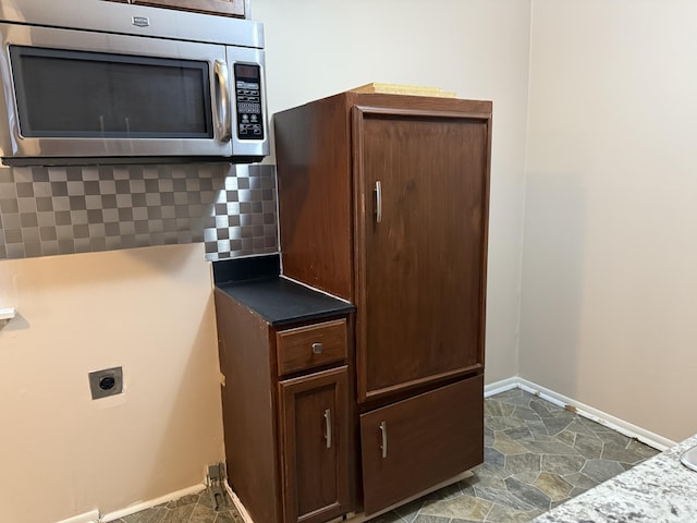 5839 Ballfour, Allen Park, MI 48101 - laundry view of stainless steel microwave and decorative backsplash