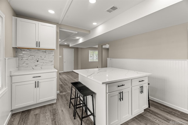 8329 Lenore St, Dearborn Heights, MI 48127 - kitchen with wood finished floors, a kitchen breakfast bar, white cabinetry, wainscoting, and recessed lighting