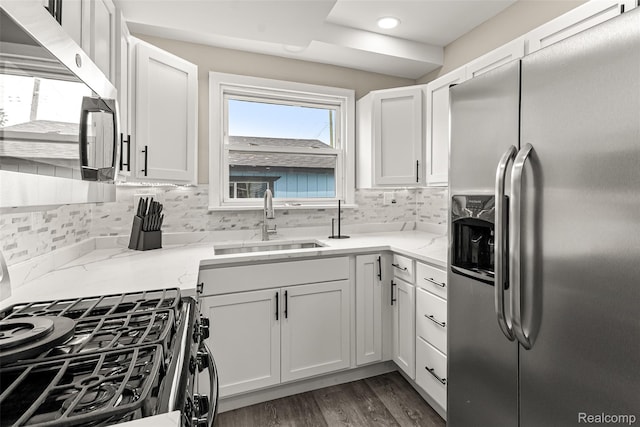 8329 Lenore St, Dearborn Heights, MI 48127 - kitchen featuring appliances with stainless steel finishes, backsplash, light stone counters, white cabinets, and recessed lighting