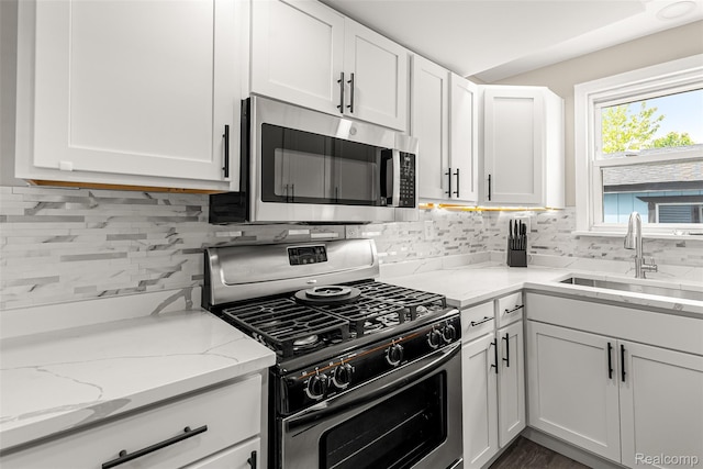 8329 Lenore St, Dearborn Heights, MI 48127 - kitchen featuring stainless steel appliances, white cabinetry, and backsplash