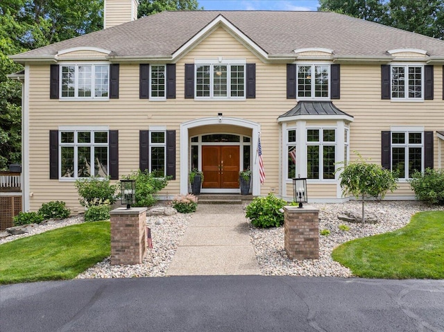 4608 Old Grand River Trl NE, Ada, MI 49301 - colonial-style house with a chimney and a shingled roof