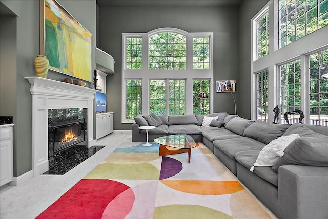 4608 Old Grand River Trl NE, Ada, MI 49301 - living area featuring a high ceiling and a premium fireplace