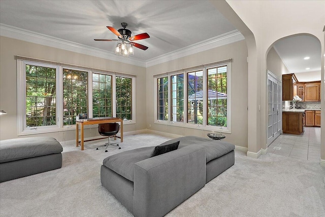 4608 Old Grand River Trl NE, Ada, MI 49301 - living room featuring light carpet, arched walkways, a ceiling fan, crown molding, and a desk