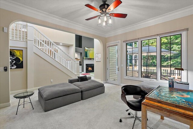 4608 Old Grand River Trl NE, Ada, MI 49301 - carpeted office featuring crown molding, ceiling fan, arched walkways, and a lit fireplace
