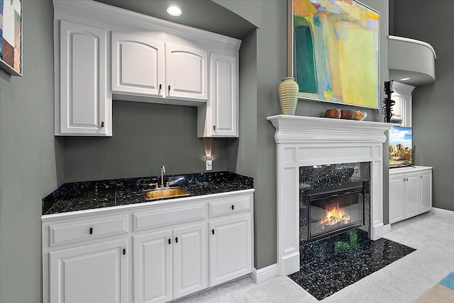 4608 Old Grand River Trl NE, Ada, MI 49301 - kitchen with white cabinets, a fireplace, and light colored carpet
