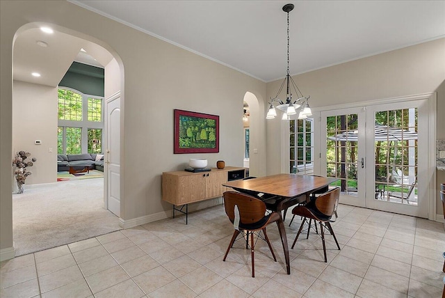 4608 Old Grand River Trl NE, Ada, MI 49301 - dining space with arched walkways, french doors, light colored carpet, light tile patterned flooring, and ornamental molding
