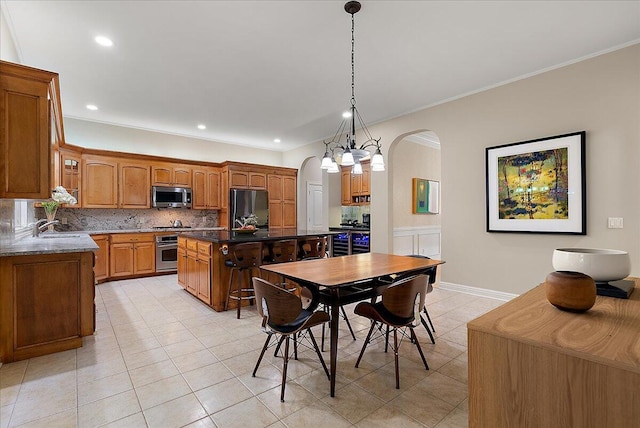 4608 Old Grand River Trl NE, Ada, MI 49301 - dining space with arched walkways, light tile patterned flooring, crown molding, and recessed lighting