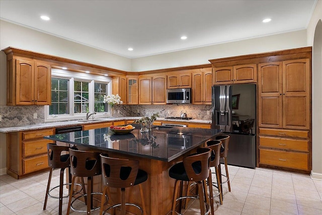 4608 Old Grand River Trl NE, Ada, MI 49301 - kitchen with appliances with stainless steel finishes, brown cabinetry, a breakfast bar area, recessed lighting, and crown molding