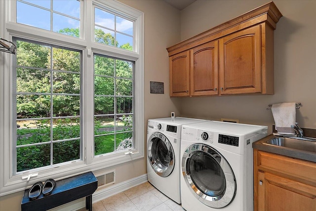 4608 Old Grand River Trl NE, Ada, MI 49301 - laundry room featuring cabinet space, separate washer and dryer, plenty of natural light, and light tile patterned floors