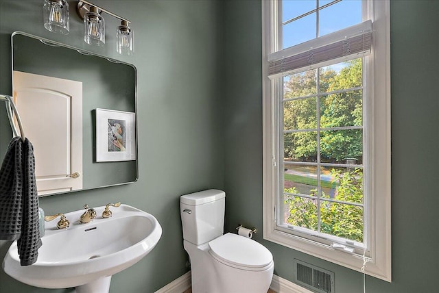 4608 Old Grand River Trl NE, Ada, MI 49301 - half bath featuring a sink and baseboards