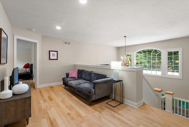 4608 Old Grand River Trl NE, Ada, MI 49301 - living room featuring light wood-style floors and recessed lighting