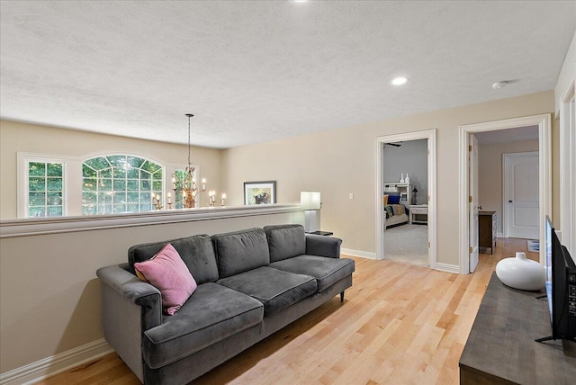 4608 Old Grand River Trl NE, Ada, MI 49301 - living area featuring a chandelier, light wood-style floors, a textured ceiling, and recessed lighting