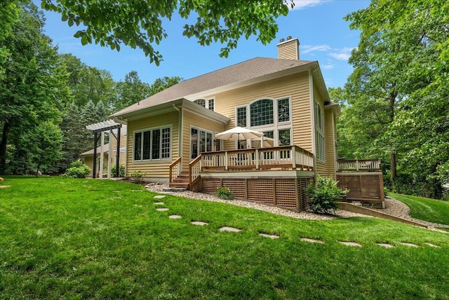 4608 Old Grand River Trl NE, Ada, MI 49301 - rear view of property featuring a chimney, a deck, and a yard
