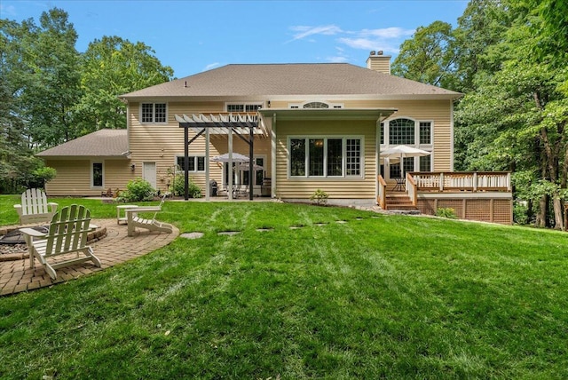 4608 Old Grand River Trl NE, Ada, MI 49301 - back of property with a pergola, a deck, a chimney, and a yard