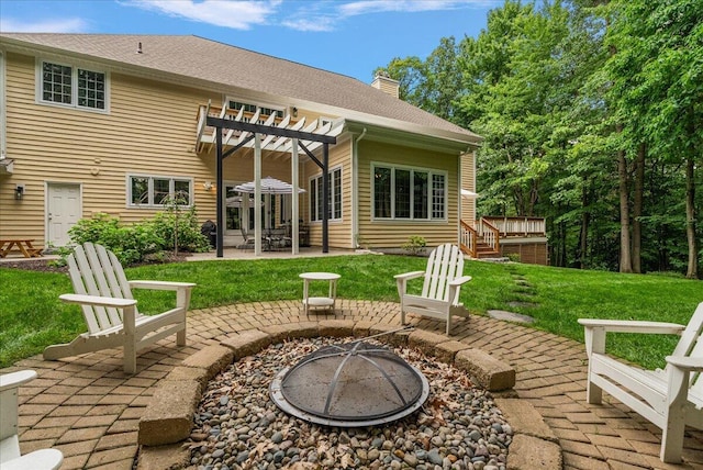 4608 Old Grand River Trl NE, Ada, MI 49301 - view of patio featuring a fire pit, a pergola, and a wooden deck
